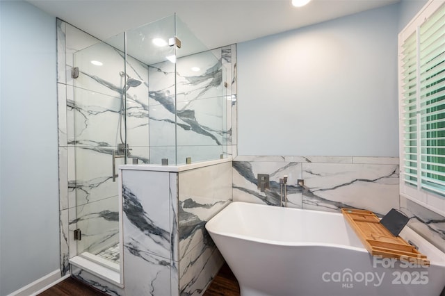 3041 Shallowood Ln, Charlotte, NC 28277 - full bath with tile walls, a freestanding tub, a marble finish shower, wood finished floors, and recessed lighting