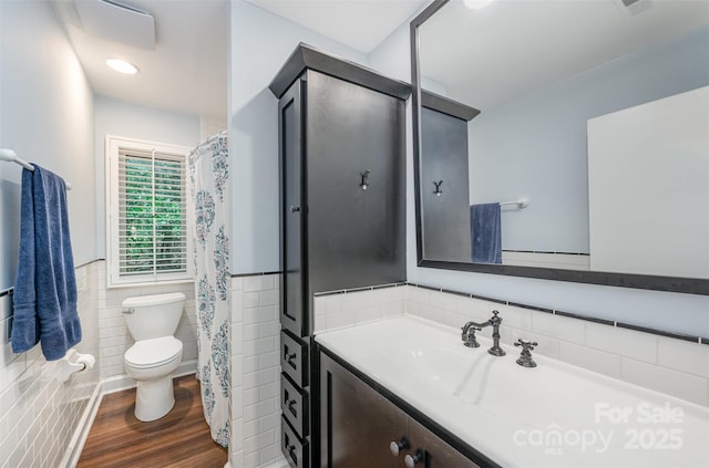 3041 Shallowood Ln, Charlotte, NC 28277 - full bath with tile walls, vanity, wainscoting, wood finished floors, and curtained shower