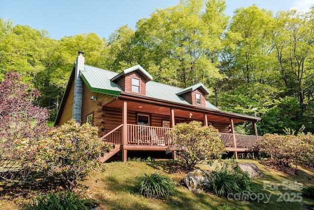 2266 Sugar Mountain Rd, Newland, NC 28657 - view of front facade featuring a porch, log siding, a chimney, a metal roof, and a view of trees