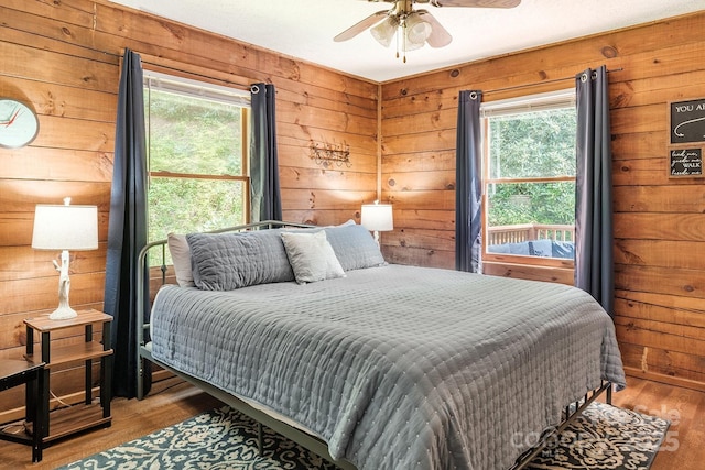 2266 Sugar Mountain Rd, Newland, NC 28657 - bedroom with wood walls, wood finished floors, and a ceiling fan