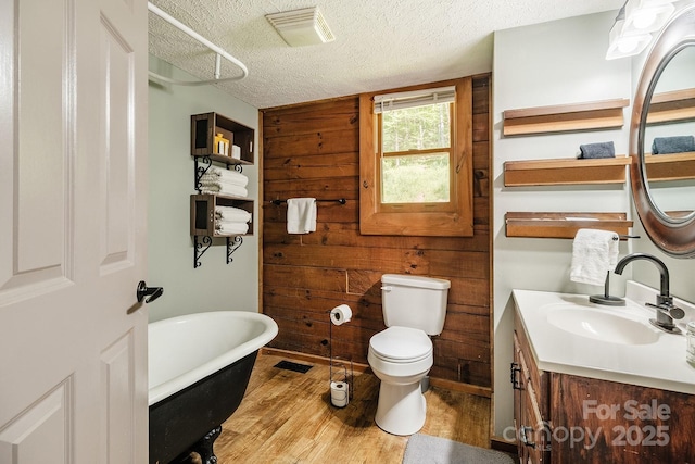 2266 Sugar Mountain Rd, Newland, NC 28657 - full bath featuring a textured ceiling, wood finished floors, a freestanding bath, and vanity