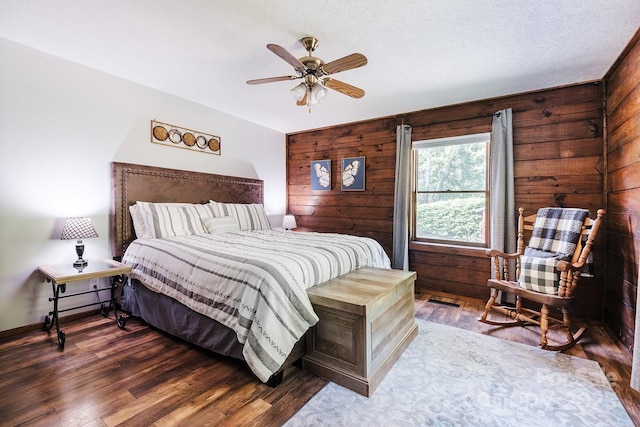 2266 Sugar Mountain Rd, Newland, NC 28657 - bedroom with wooden walls, wood finished floors, and a ceiling fan