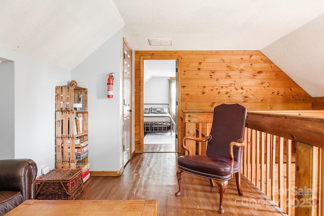2266 Sugar Mountain Rd, Newland, NC 28657 - sitting room with wood finished floors, vaulted ceiling, and a textured ceiling