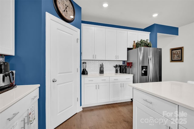 2473 Riparian Way, Denver, NC 28037 - kitchen featuring stainless steel fridge, tasteful backsplash, white cabinets, light countertops, and wood finished floors