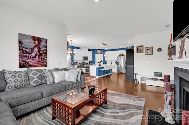 2473 Riparian Way, Denver, NC 28037 - living area featuring wood finished floors, a fireplace with flush hearth, recessed lighting, and a chandelier