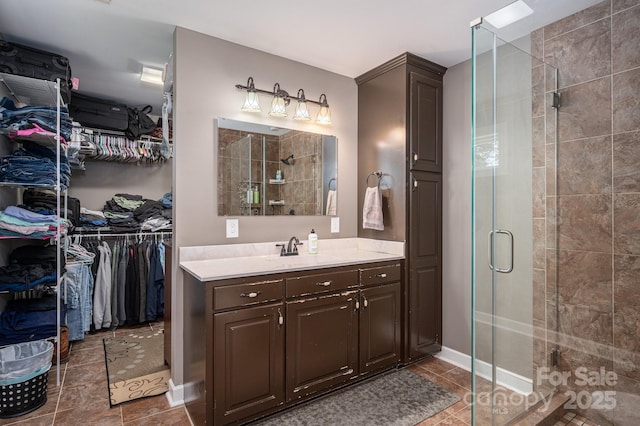 4441 Jim Wise Rd, Lincolnton, NC 28092 - bathroom featuring vanity, a stall shower, tile patterned floors, and a walk in closet