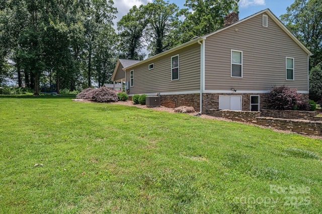 4441 Jim Wise Rd, Lincolnton, NC 28092 - view of side of property with a chimney, a yard, and stone siding