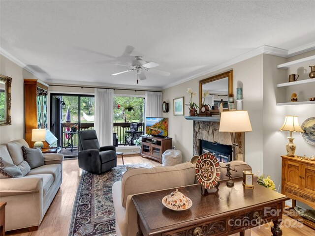 87 Willow Rd Unit D-4, Waynesville, NC 28786 - living area with light wood-style flooring, ceiling fan, a fireplace, and ornamental molding