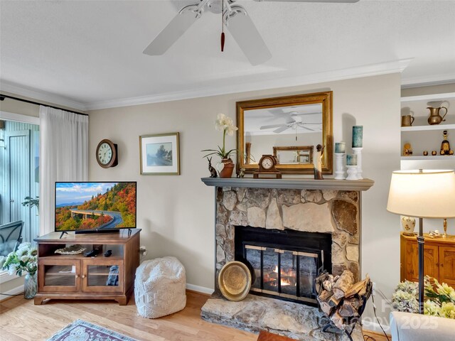 87 Willow Rd Unit D-4, Waynesville, NC 28786 - living room featuring ceiling fan, a fireplace, crown molding, and wood finished floors