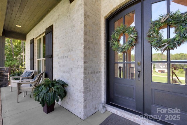 2122 Goose Creek Farm Ln, Indian Trail, NC 28079 - view of exterior entry featuring french doors, covered porch, and brick siding