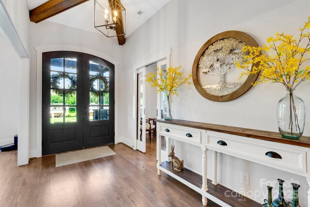 2122 Goose Creek Farm Ln, Indian Trail, NC 28079 - foyer featuring french doors, a chandelier, wood finished floors, beamed ceiling, and high vaulted ceiling