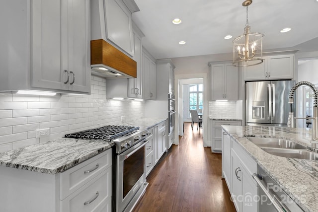 2122 Goose Creek Farm Ln, Indian Trail, NC 28079 - kitchen with appliances with stainless steel finishes, a chandelier, light stone countertops, recessed lighting, and pendant lighting