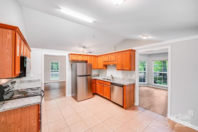 9000 Vagabond Rd, Charlotte, NC 28227 - kitchen featuring stainless steel appliances, vaulted ceiling, healthy amount of natural light, and light tile patterned floors