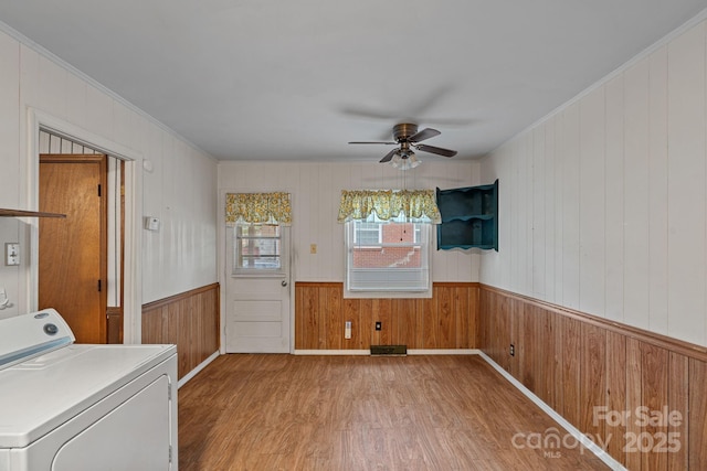 807 Claremont Rd, Charlotte, NC 28214 - laundry area with washer / dryer, light wood finished floors, a ceiling fan, wood walls, and crown molding