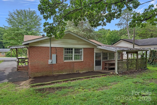 807 Claremont Rd, Charlotte, NC 28214 - back of house featuring brick siding, a lawn, crawl space, and a shingled roof