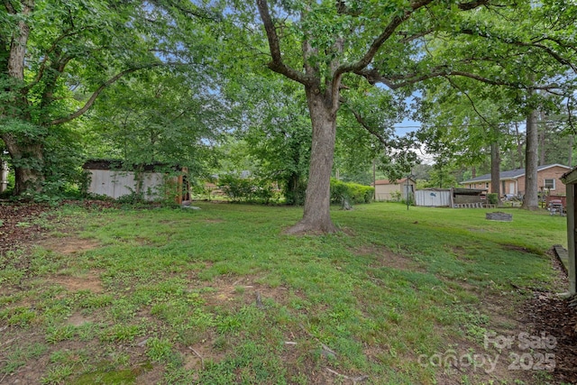 807 Claremont Rd, Charlotte, NC 28214 - view of grassy yard featuring a shed