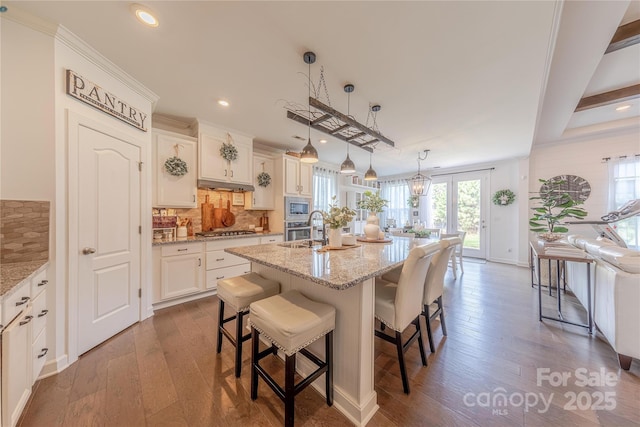 1178 Arges River Dr, Fort Mill, SC 29715 - kitchen with appliances with stainless steel finishes, a breakfast bar, tasteful backsplash, dark wood-style flooring, and recessed lighting
