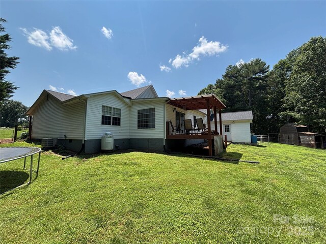 8122 Hutchison Ln, Vale, NC 28168 - back of property with a trampoline, a pergola, a lawn, a shed, and a deck