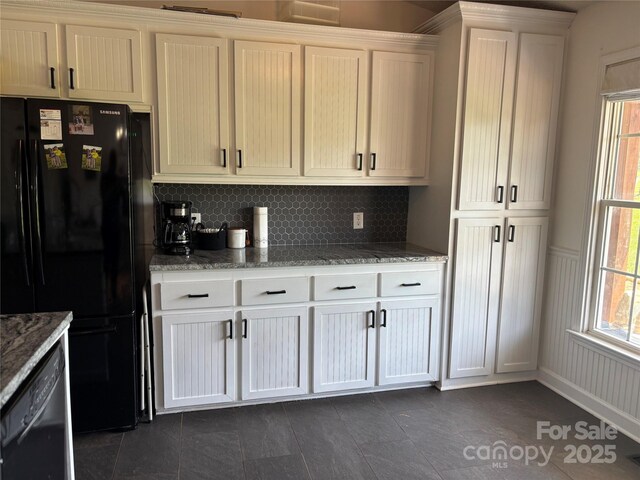 8122 Hutchison Ln, Vale, NC 28168 - kitchen featuring black appliances, healthy amount of natural light, light stone countertops, and decorative backsplash