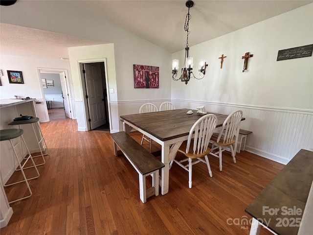 8122 Hutchison Ln, Vale, NC 28168 - dining space featuring hardwood / wood-style flooring, lofted ceiling, a wainscoted wall, and a chandelier