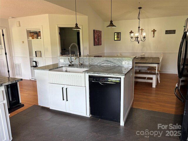 8122 Hutchison Ln, Vale, NC 28168 - kitchen featuring black appliances, wainscoting, a chandelier, light stone countertops, and hanging light fixtures