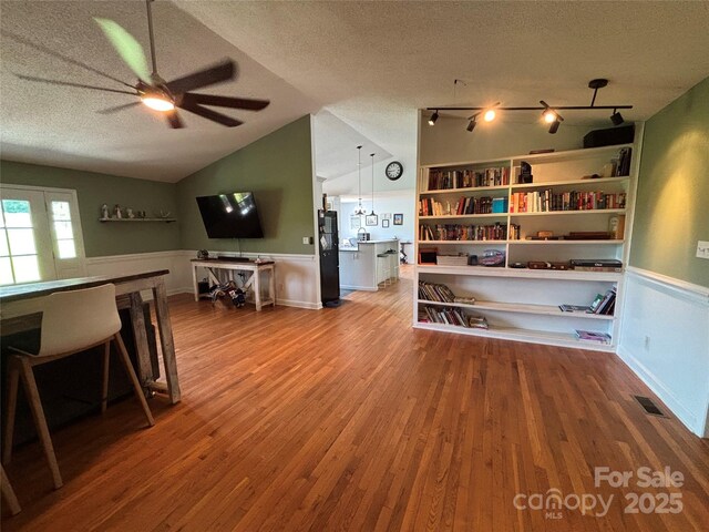 8122 Hutchison Ln, Vale, NC 28168 - living room with a textured ceiling, ceiling fan, wood finished floors, wainscoting, and vaulted ceiling