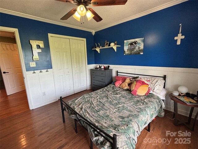 8122 Hutchison Ln, Vale, NC 28168 - bedroom featuring ornamental molding, wainscoting, wood finished floors, a closet, and a ceiling fan
