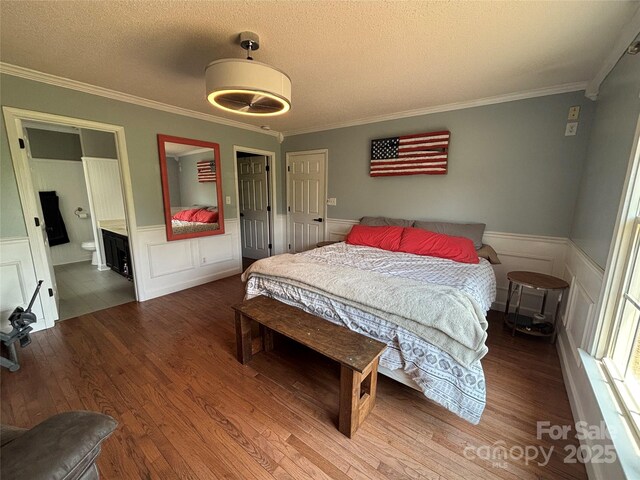 8122 Hutchison Ln, Vale, NC 28168 - bedroom featuring ornamental molding, wood finished floors, a wainscoted wall, a textured ceiling, and a decorative wall