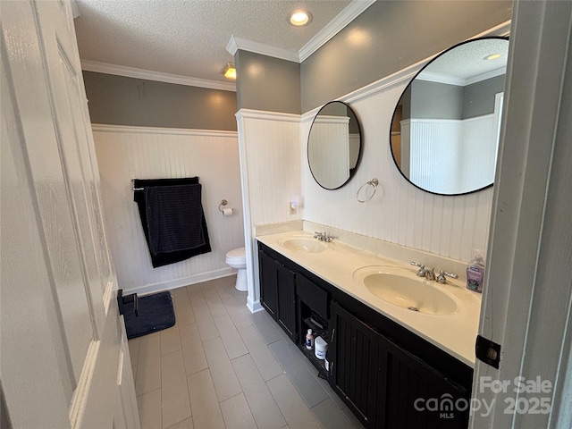 8122 Hutchison Ln, Vale, NC 28168 - bathroom with double vanity, wainscoting, a textured ceiling, and ornamental molding