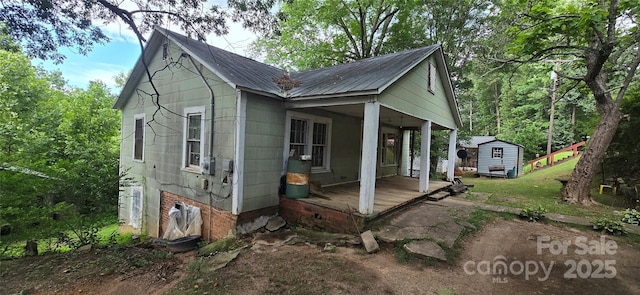 127 Hibriten Mountain Rd, Lenoir, NC 28645 - view of property exterior featuring a storage shed, a porch, and a metal roof