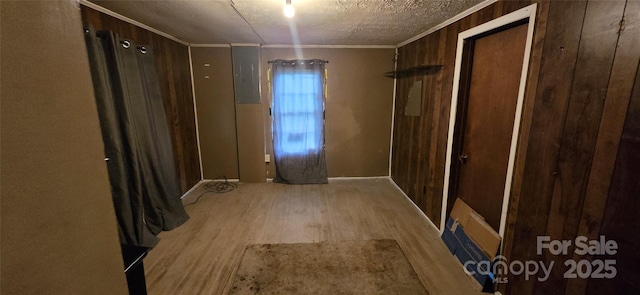 127 Hibriten Mountain Rd, Lenoir, NC 28645 - corridor featuring wood finished floors, ornamental molding, wooden walls, electric panel, and a textured ceiling