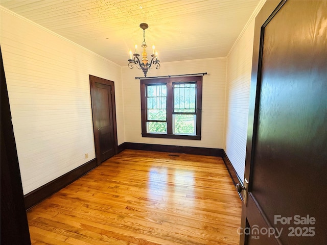 5188 Dysartsville Rd, Morganton, NC 28655 - unfurnished room featuring crown molding, a chandelier, and wood finished floors