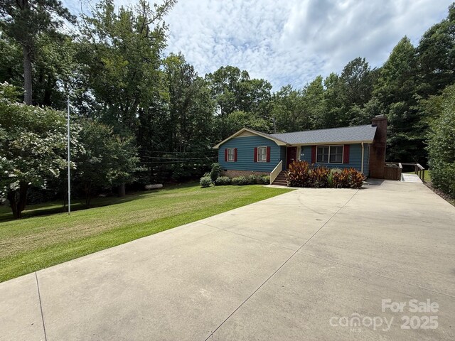 200 Breslin St, Wadesboro, NC 28170 - view of front of home with driveway, a chimney, and a front yard