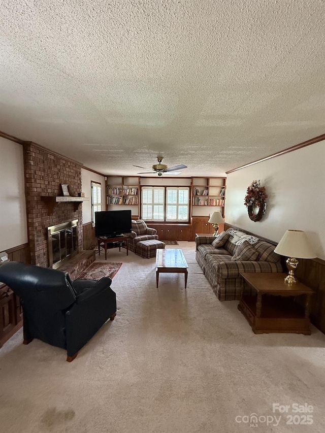 200 Breslin St, Wadesboro, NC 28170 - carpeted living area featuring a textured ceiling, crown molding, plenty of natural light, a brick fireplace, and a ceiling fan