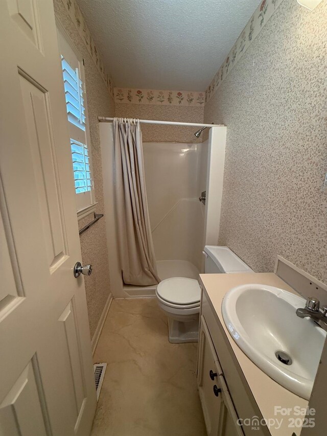 200 Breslin St, Wadesboro, NC 28170 - full bathroom with a stall shower, vanity, and a textured ceiling