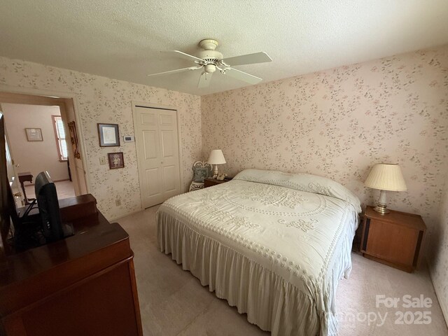200 Breslin St, Wadesboro, NC 28170 - bedroom featuring a closet, wallpapered walls, light carpet, a ceiling fan, and a textured ceiling