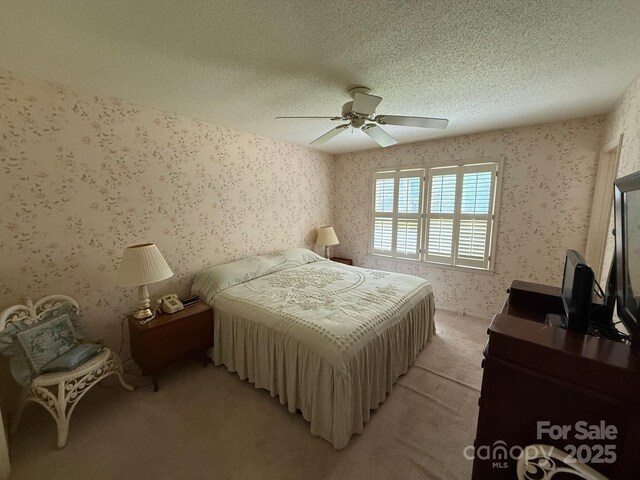 200 Breslin St, Wadesboro, NC 28170 - bedroom featuring wallpapered walls, light colored carpet, a textured ceiling, and ceiling fan