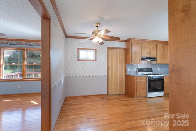 5211 Spring Gln, York, SC 29745 - kitchen with white range with gas cooktop, ornamental molding, wallpapered walls, ceiling fan, and light wood-style floors
