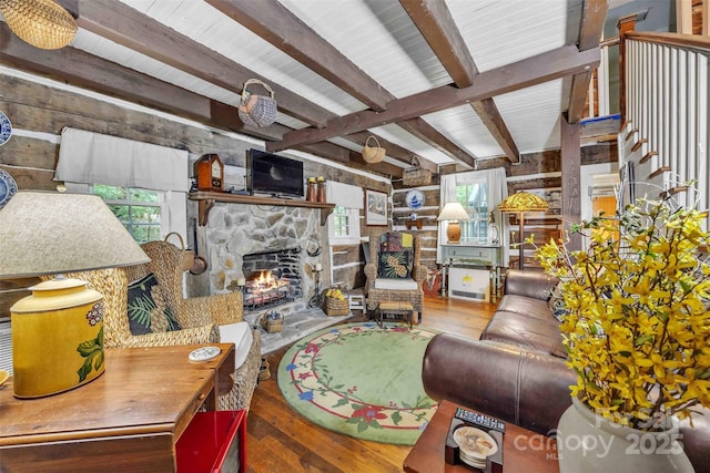 189 Woodstock Dr, West Jefferson, NC 28694 - living area with a stone fireplace, wood-type flooring, beamed ceiling, and wooden walls