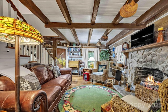 189 Woodstock Dr, West Jefferson, NC 28694 - living room with wood finished floors, beam ceiling, stairs, and a stone fireplace