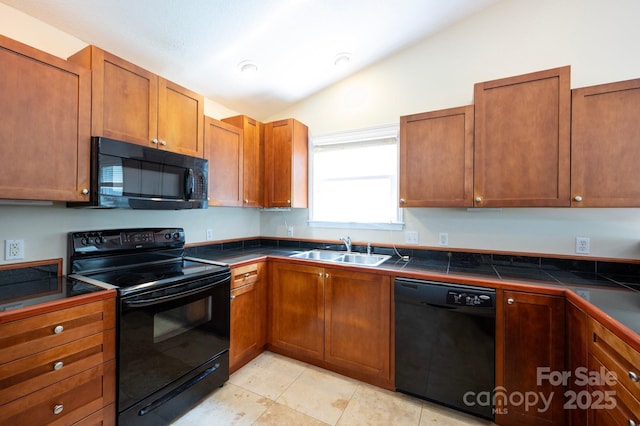 29 Honey Hollow Ln, Fairview, NC 28730 - kitchen featuring black appliances, vaulted ceiling, brown cabinetry, light tile patterned floors, and tile counters