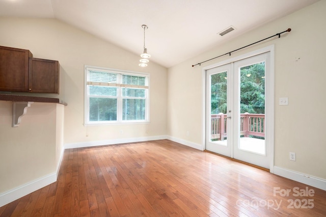 29 Honey Hollow Ln, Fairview, NC 28730 - unfurnished dining area featuring french doors, vaulted ceiling, and light wood-style floors