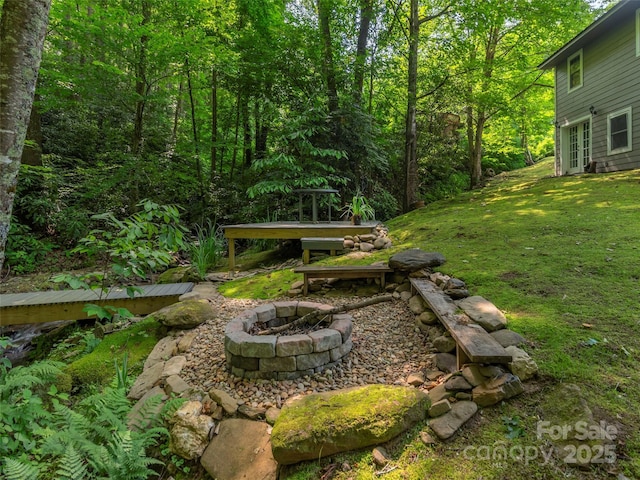 1131 Laurel Branch Rd, Waynesville, NC 28785 - view of green lawn with an outdoor fire pit, french doors, and a forest view