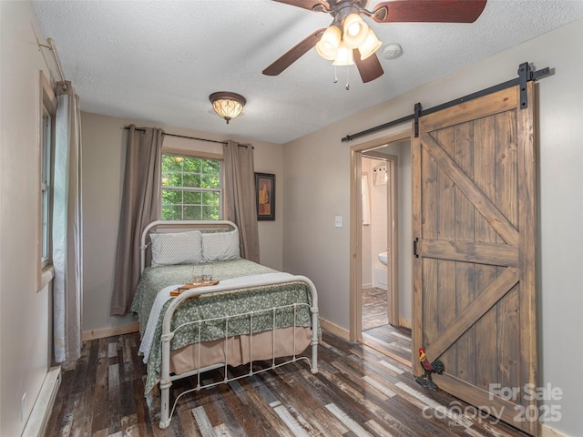 1131 Laurel Branch Rd, Waynesville, NC 28785 - bedroom with a baseboard radiator, a barn door, a textured ceiling, dark wood-type flooring, and a ceiling fan