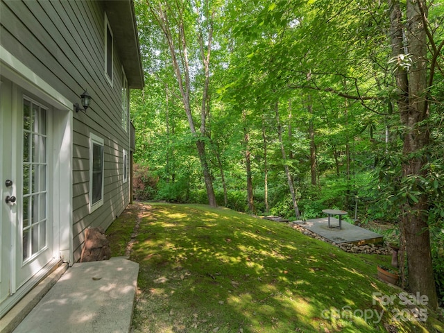 1131 Laurel Branch Rd, Waynesville, NC 28785 - view of grassy yard featuring a forest view and a patio area