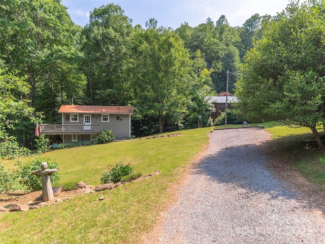 1131 Laurel Branch Rd, Waynesville, NC 28785 - view of front of house featuring gravel driveway, a front lawn, a view of trees, and a deck