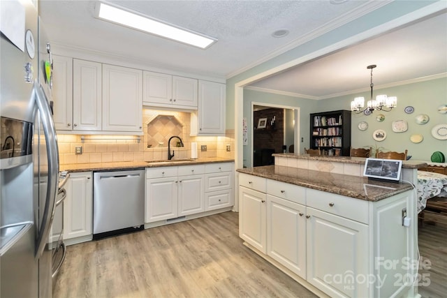 3092 Hitching Post Ln, Rock Hill, SC 29732 - kitchen featuring stainless steel appliances, white cabinetry, light wood-type flooring, and crown molding
