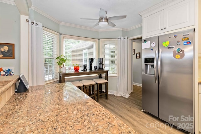 3092 Hitching Post Ln, Rock Hill, SC 29732 - kitchen featuring stainless steel fridge, ceiling fan, light wood finished floors, white cabinetry, and crown molding