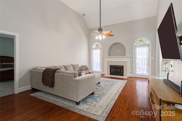 4605 Sarandon Ct, Charlotte, NC 28215 - living room featuring high vaulted ceiling, hardwood / wood-style floors, a ceiling fan, and a fireplace