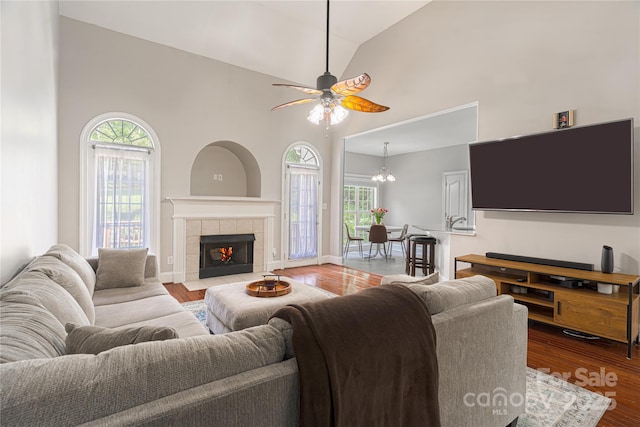 4605 Sarandon Ct, Charlotte, NC 28215 - living area with plenty of natural light, high vaulted ceiling, wood finished floors, ceiling fan, and a fireplace